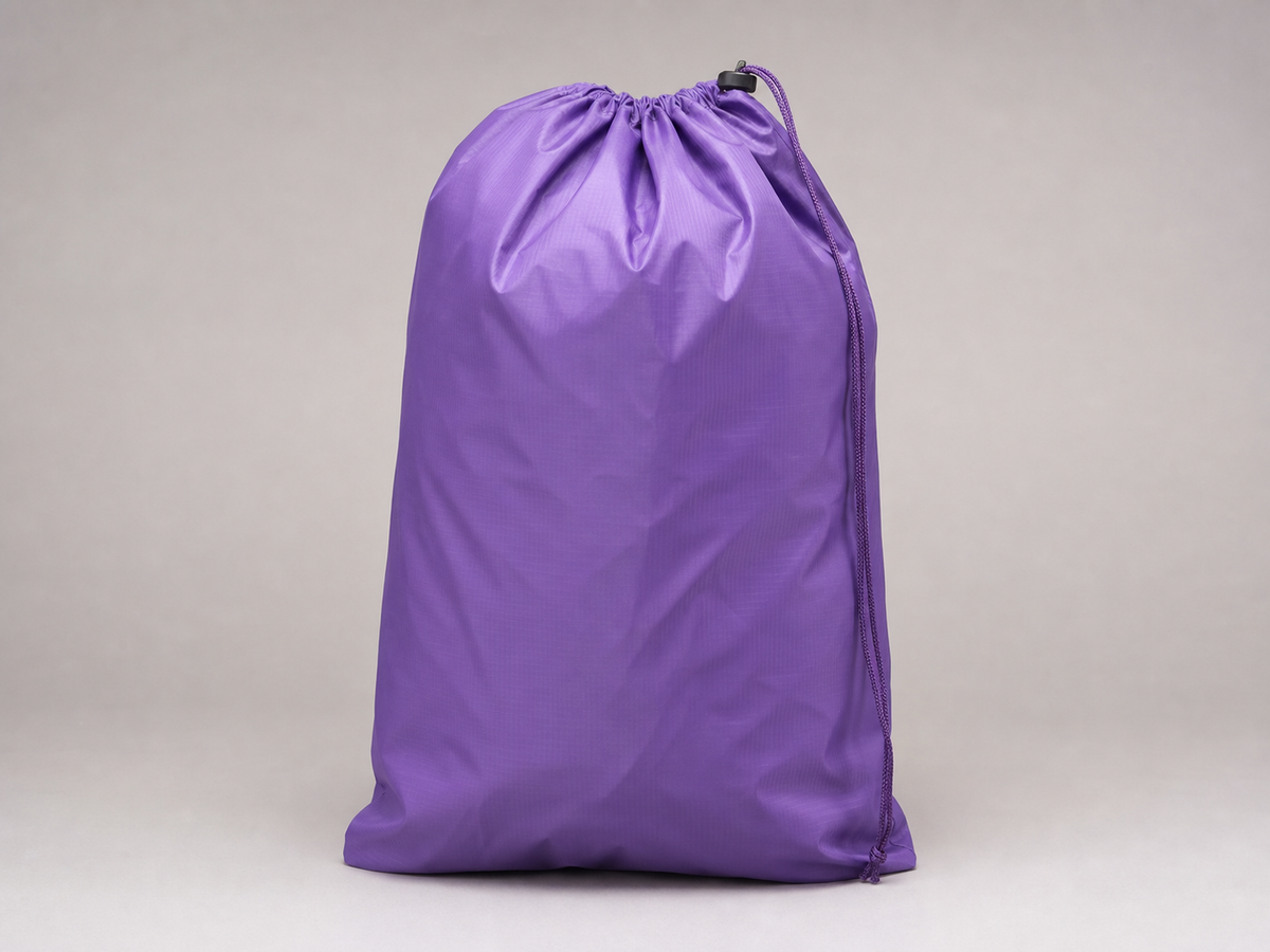 Illustration of a purple drawstring laundry bag.
